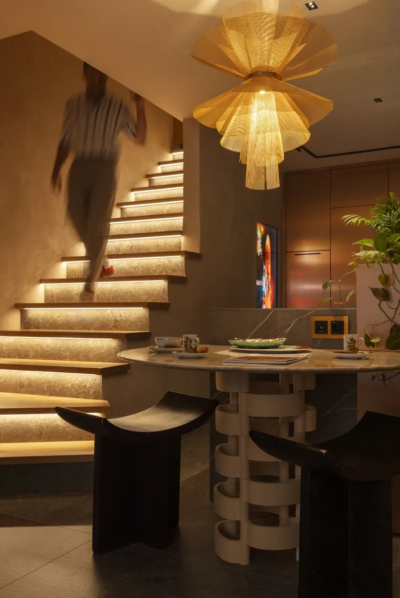 Ritual's showroom in Barcelona, with a lit staircase and a stone table